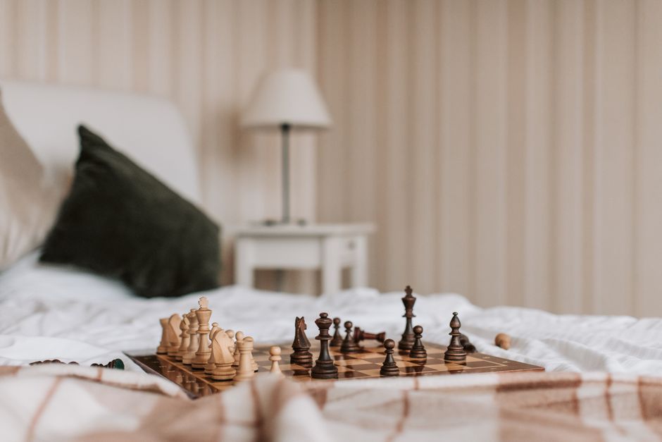 A close-up of a minimalist chess game in progress, representing the strategic foresight and planning involved in a realtor's SEO strategy to address client questions.