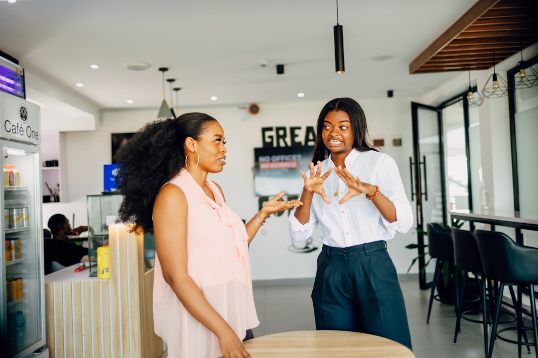 Two professionals shaking hands in front of a charming local business storefront, illustrating the concept of building authority through community links and partnerships.