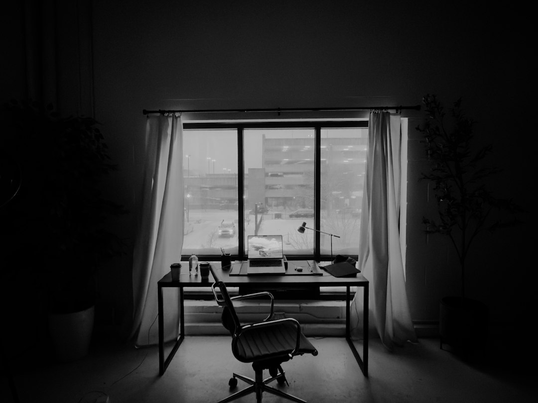 An overhead view of a clean, modern desk with architectural blueprints laid out, representing a well-engineered and precise strategy for real estate SEO.