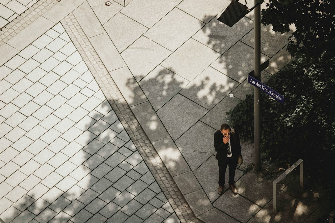 A person in professional attire walking down a well-lit, modern, and unobstructed hallway, representing a frictionless path to lead generation.